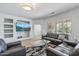 Living room boasts a large-screen TV, neutral decor, and plenty of seating at 19225 N Tallowood Way, Surprise, AZ 85387