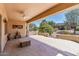 Spacious covered patio with ceiling fan, patterned concrete, and scenic backyard views at 19225 N Tallowood Way, Surprise, AZ 85387
