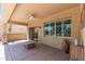 This covered patio features a ceiling fan, decorative vases, stamped concrete, and views of the backyard landscaping at 19225 N Tallowood Way, Surprise, AZ 85387
