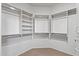 Walk-in closet with built-in shelves and rods for organized storage space at 19225 N Tallowood Way, Surprise, AZ 85387