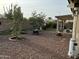Expansive backyard showcasing a spacious patio area and desert landscaping at 20298 N 108Th Ln, Sun City, AZ 85373