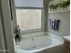 Bathroom featuring large soaking tub and neutral accents at 20298 N 108Th Ln, Sun City, AZ 85373