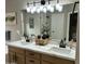 Bathroom featuring double sinks with modern fixtures and lots of natural light at 20298 N 108Th Ln, Sun City, AZ 85373
