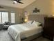 Serene main bedroom features a plush bed, soft lighting, and a peaceful ambiance at 20298 N 108Th Ln, Sun City, AZ 85373