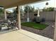 Inviting covered patio with comfortable seating and a manicured backyard featuring artificial turf at 20298 N 108Th Ln, Sun City, AZ 85373