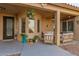 Open-air patio with comfortable seating, a ceiling fan, desert themed yard decor and textured walls at 20423 W Springfield St, Buckeye, AZ 85396