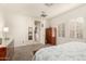 Carpeted bedroom with white walls, shuttered windows, a closet and an ensuite bathroom door at 20423 W Springfield St, Buckeye, AZ 85396