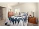 Bright bedroom featuring natural light, neutral walls, a patterned quilt, and classic wood furnishings at 20423 W Springfield St, Buckeye, AZ 85396