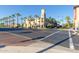 An exterior view of a multi-story building featuring commercial space and a clock tower, surrounded by mature landscaping at 20423 W Springfield St, Buckeye, AZ 85396