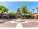 The entrance of this community features a water fountain and mature landscaping, adding to the community's curb appeal at 20423 W Springfield St, Buckeye, AZ 85396