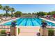 A large, inviting community pool surrounded by lounge chairs and lush landscaping, perfect for relaxation and recreation at 20423 W Springfield St, Buckeye, AZ 85396
