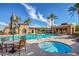 Inviting community pool and spa area with comfortable seating, shaded umbrellas, and well-maintained landscaping at 20423 W Springfield St, Buckeye, AZ 85396