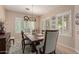 Bright dining room with stylish chandelier, large windows, tile floors and decor at 20423 W Springfield St, Buckeye, AZ 85396