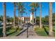 Picturesque view of a clock tower framed by palm trees and a water fountain at 20423 W Springfield St, Buckeye, AZ 85396