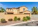 Charming stucco two-story home features a tile roof, solar panels, and a lovely front yard at 20423 W Springfield St, Buckeye, AZ 85396