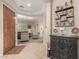 Light-filled foyer leads to a living room with tile flooring, elegant decor and accent pieces at 20423 W Springfield St, Buckeye, AZ 85396