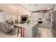 Bright kitchen with granite countertops, stainless appliances, an island with seating and tile flooring at 20423 W Springfield St, Buckeye, AZ 85396