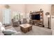 Gathering room features a comfortable sofa, recliner, carpeting and a large entertainment center at 20423 W Springfield St, Buckeye, AZ 85396