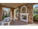 Cozy outdoor seating area featuring a stone fireplace perfect for relaxing and enjoying the community at 20423 W Springfield St, Buckeye, AZ 85396