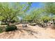 Inviting neighborhood park featuring picnic tables and lush greenery, ideal for outdoor gatherings and relaxation at 20423 W Springfield St, Buckeye, AZ 85396