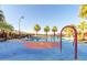 Fun splash pad area and pool with seating surrounded by palm trees at 20423 W Springfield St, Buckeye, AZ 85396