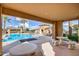 Relaxing poolside patio area with comfortable seating, providing a perfect spot to unwind and enjoy the pool view at 20423 W Springfield St, Buckeye, AZ 85396