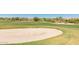 Scenic view of the golf course with a sand trap in the foreground and luxury homes in the background at 20423 W Springfield St, Buckeye, AZ 85396