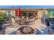 Inviting back patio with a built-in fire pit, a grill, and an outdoor seating area at 20581 N Enchantment Pass, Maricopa, AZ 85138