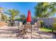 Outdoor patio area features a dining table, grill, desert landscaping, and a fire pit at 20581 N Enchantment Pass, Maricopa, AZ 85138