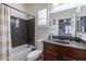 Bathroom with a shower-tub combo, toilet, and dark wood vanity with a granite top at 20581 N Enchantment Pass, Maricopa, AZ 85138