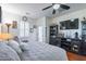 Bedroom with wood floors, an entertainment center, and a view to the outside at 20581 N Enchantment Pass, Maricopa, AZ 85138