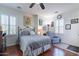 Spacious bedroom featuring wood flooring, natural light, and a ceiling fan at 20581 N Enchantment Pass, Maricopa, AZ 85138