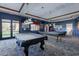 Spacious billiard room with two covered tables and outside access at 20581 N Enchantment Pass, Maricopa, AZ 85138