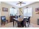 Cozy dining room features a wooden table, seating for six, and natural light at 20581 N Enchantment Pass, Maricopa, AZ 85138