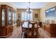 Elegant dining room boasts hardwood flooring, traditional furniture, and natural light at 20581 N Enchantment Pass, Maricopa, AZ 85138