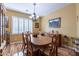 Elegant dining room with hardwood flooring and a window with shutters at 20581 N Enchantment Pass, Maricopa, AZ 85138