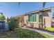 Charming single-story home with lush landscaping, tiled roof, and a brick walkway at 20581 N Enchantment Pass, Maricopa, AZ 85138