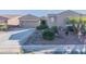 Charming home with a low-maintenance front yard, desert landscaping, and ample driveway space at 20581 N Enchantment Pass, Maricopa, AZ 85138