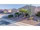 Landscaped front yard featuring drought-resistant plants, rocks, and a well-maintained lawn at 20581 N Enchantment Pass, Maricopa, AZ 85138