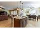 Spacious kitchen with a large center island opens up to the living and dining areas, perfect for entertaining at 20581 N Enchantment Pass, Maricopa, AZ 85138