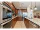 Well-equipped kitchen showcases stainless steel appliances, ample cabinet space, and granite countertops at 20581 N Enchantment Pass, Maricopa, AZ 85138