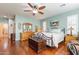 Bright main bedroom with hardwood floors, a decorative mirror, and a cozy reading nook by the windows at 20581 N Enchantment Pass, Maricopa, AZ 85138