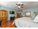 Cozy main bedroom with hardwood floors, ample storage, mounted TV, and a neutral color scheme at 20581 N Enchantment Pass, Maricopa, AZ 85138