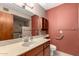 A full bathroom with a sink, toilet and shower behind a partial wall with accessibility bars at 2114 E Hale St, Mesa, AZ 85213