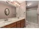 A full bathroom with a double sink and tiled shower at 2114 E Hale St, Mesa, AZ 85213