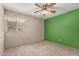 A bedroom with a ceiling fan, window, and one green wall at 2114 E Hale St, Mesa, AZ 85213