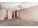 Bedroom features carpet, a ceiling fan, and closet doors, providing ample storage and a cozy space at 2114 E Hale St, Mesa, AZ 85213
