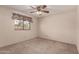 A standard bedroom with a ceiling fan and window at 2114 E Hale St, Mesa, AZ 85213