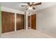 A bedroom with a ceiling fan and a closet with wood doors at 2114 E Hale St, Mesa, AZ 85213