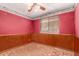 A bedroom with paneling and colorful walls, a window and ceiling fan at 2114 E Hale St, Mesa, AZ 85213